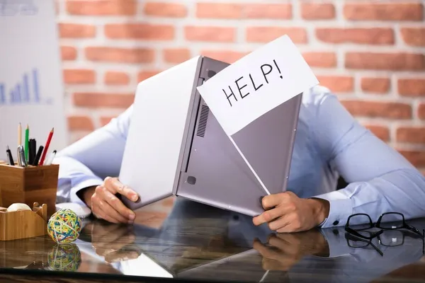 businessman covering his head with help flag