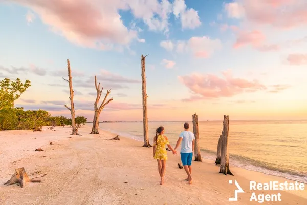 couple walking on the beach at romantic sunset