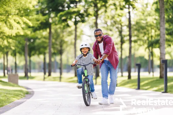 happy african american teaching cycling