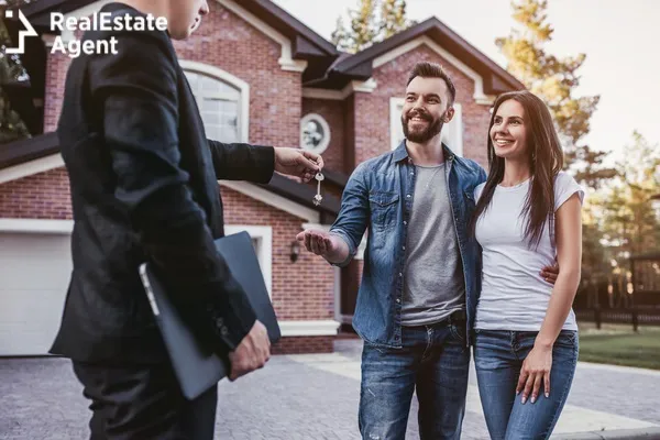 happy couple is taking the key of a new house