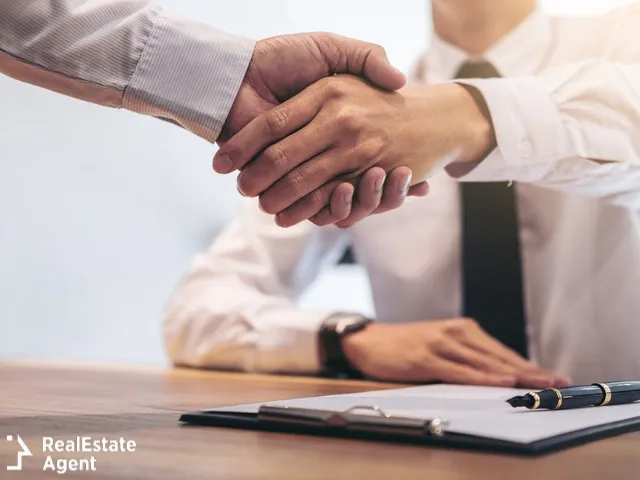 real estate agent and customer hand shaking