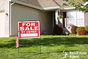 for sale by owner sign on the front of the house