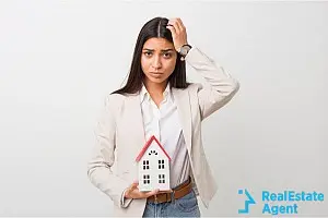 woman holding a sign with house