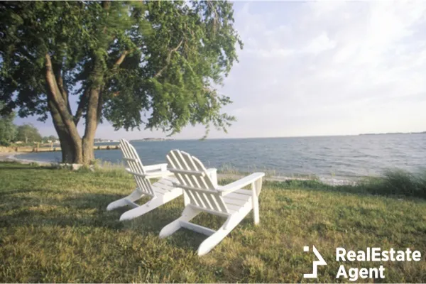 two chairs on a shore lake