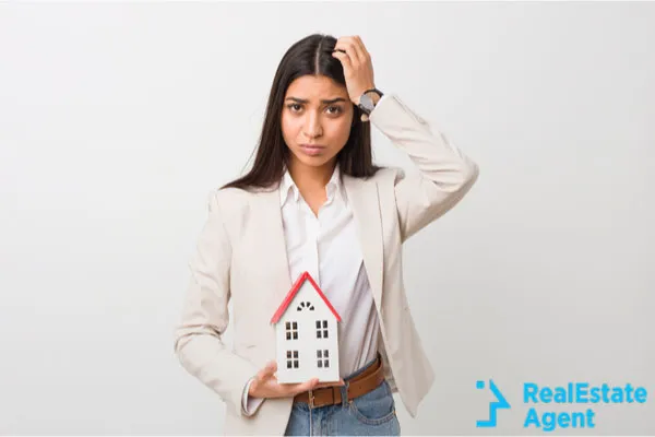 woman holding a sign with house