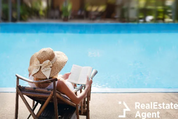 woman relaxing near luxury swimming