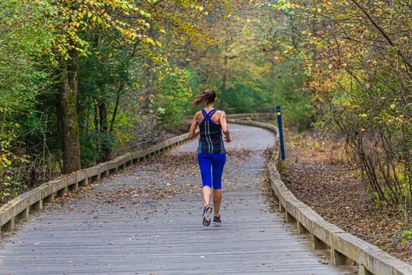 women running on paved road